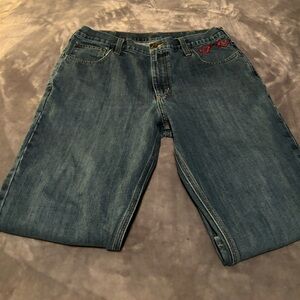 Mens carhartt jeans with hand embroidered red heart handcuffs on the pocket